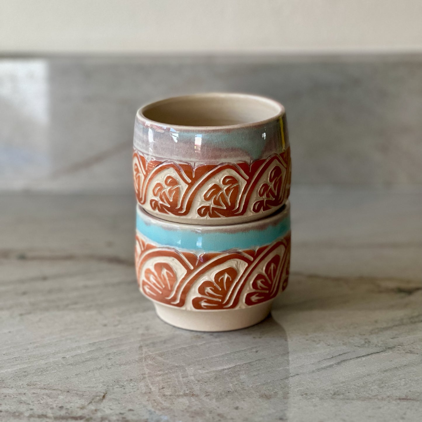 Pair of White Clay Cups, Terracotta Carving, and Blue Glaze