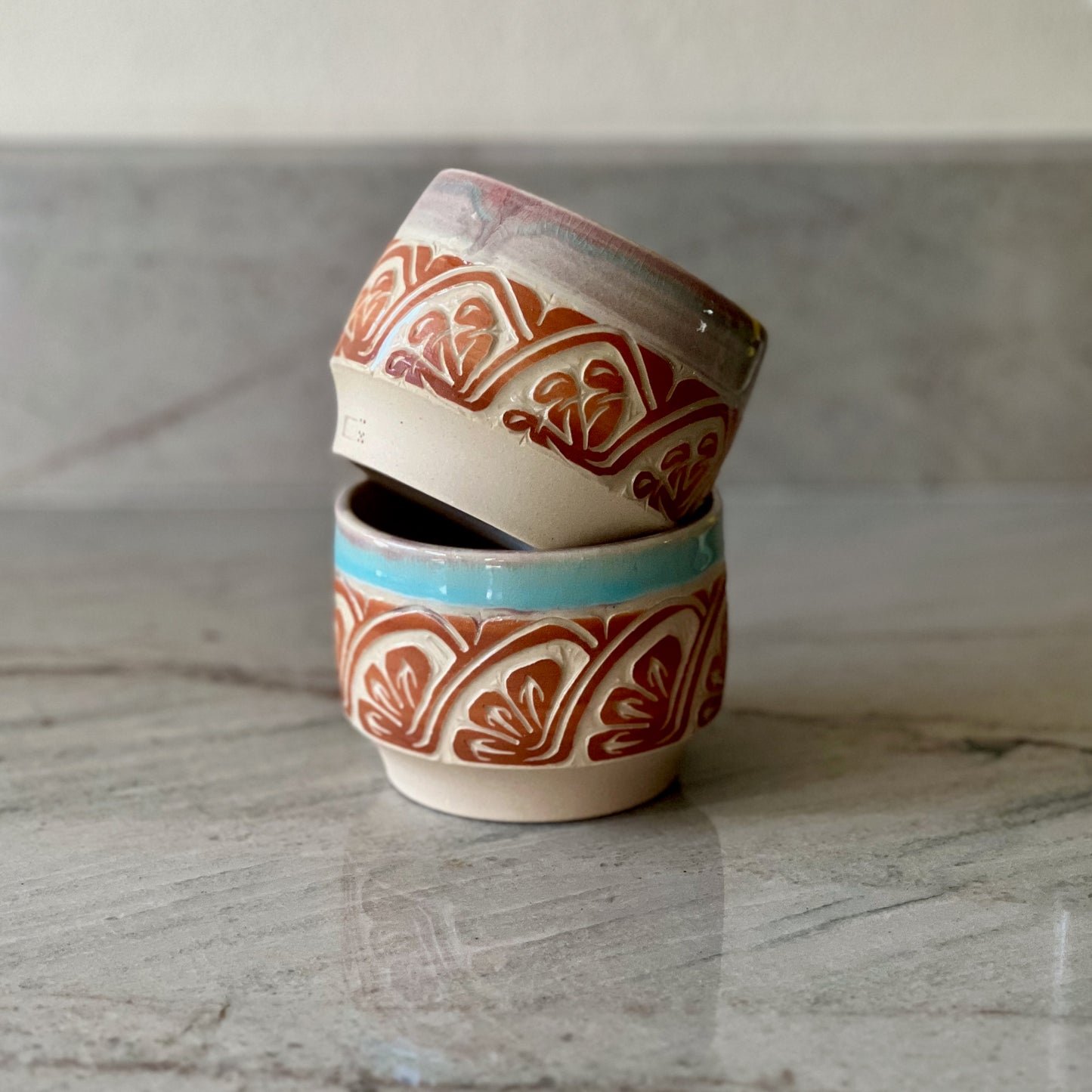 Pair of White Clay Cups, Terracotta Carving, and Blue Glaze