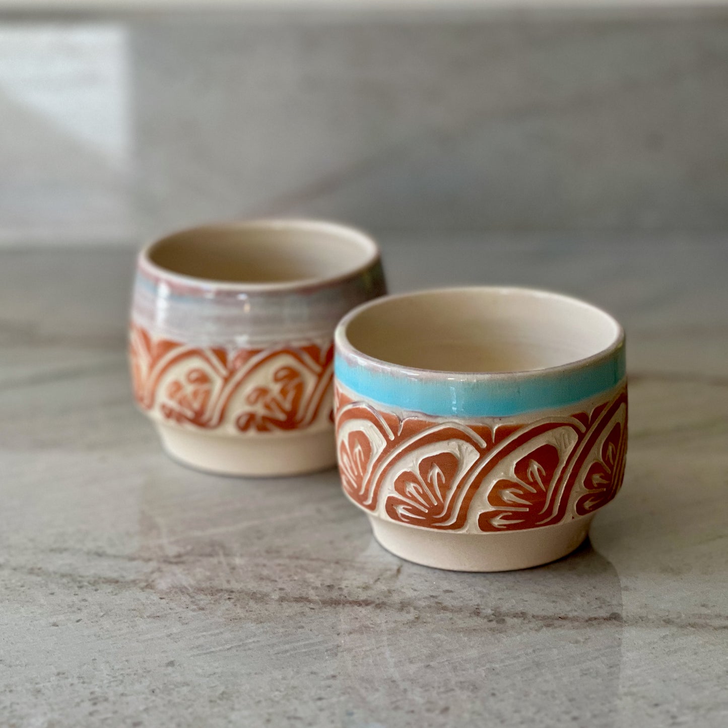 Pair of White Clay Cups, Terracotta Carving, and Blue Glaze
