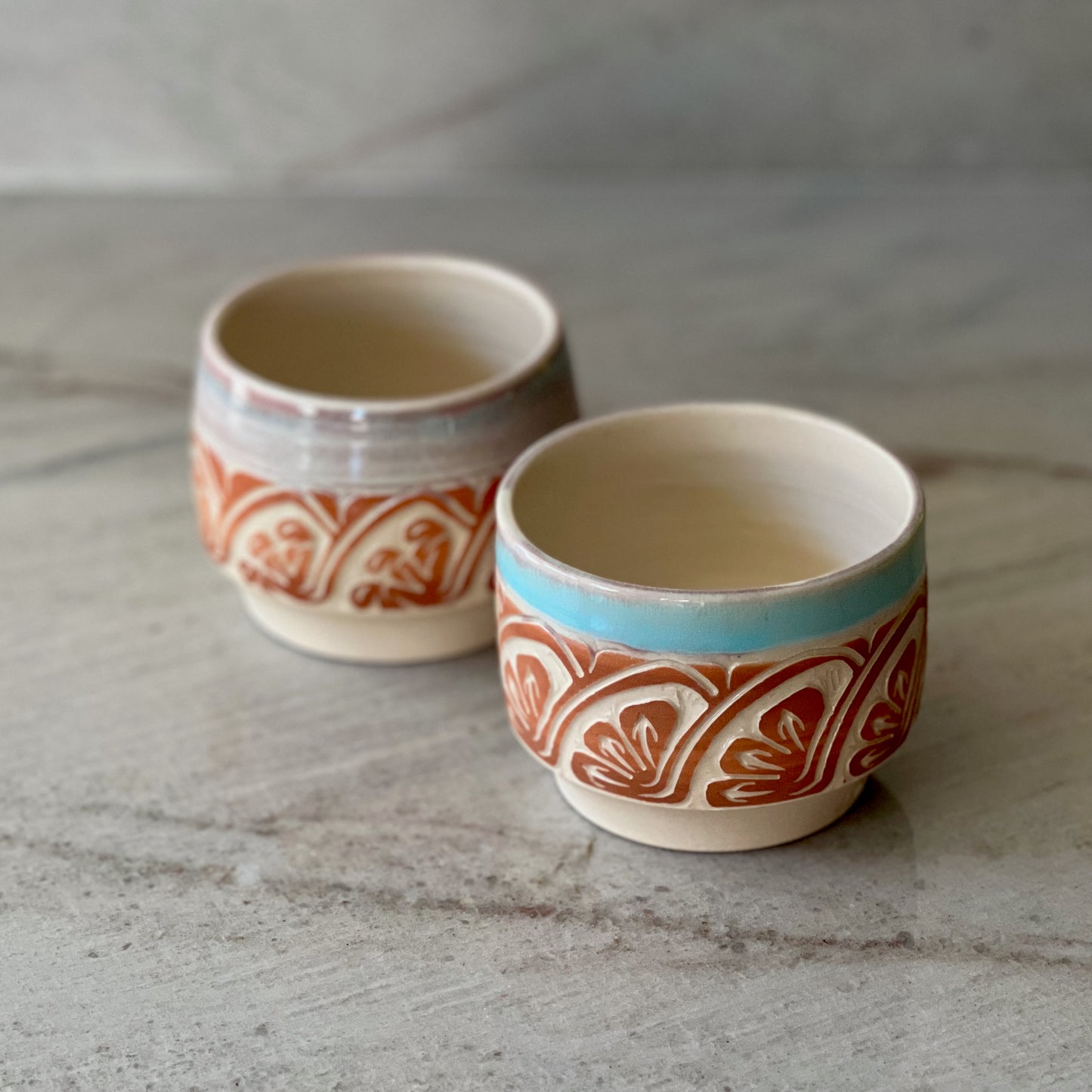 Pair of White Clay Cups, Terracotta Carving, and Blue Glaze