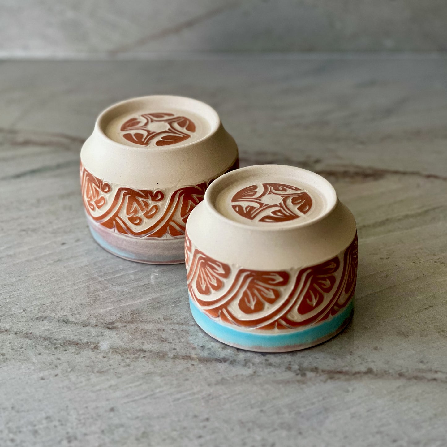 Pair of White Clay Cups, Terracotta Carving, and Blue Glaze