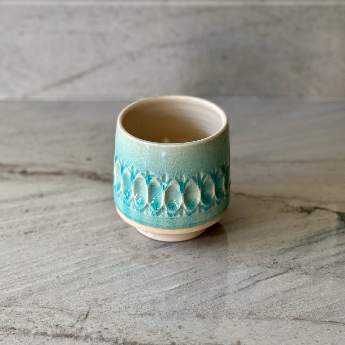 White Clay Cup With Relief Carving and Blue Glaze