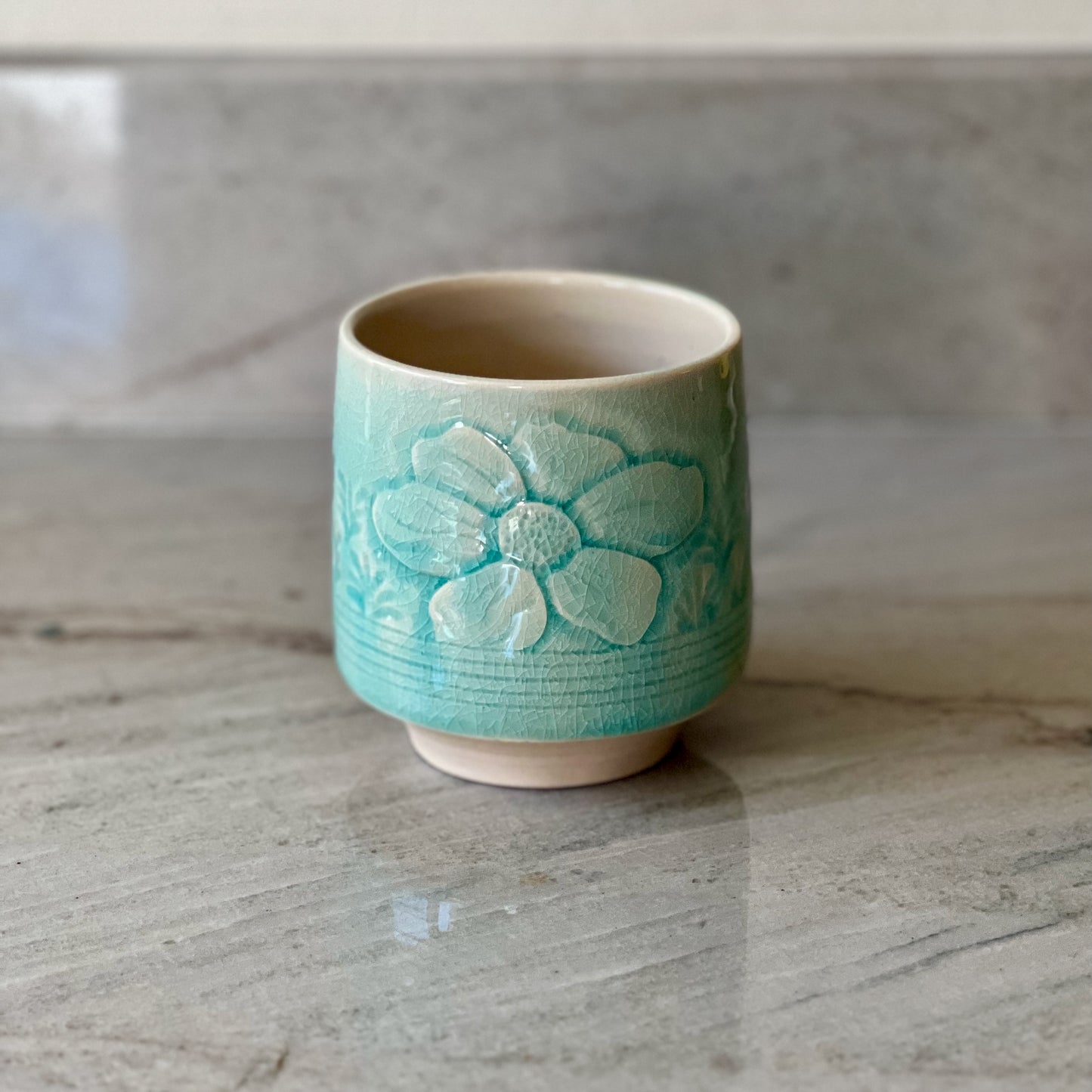 White Clay Cup With Relief Carving and Blue Glaze