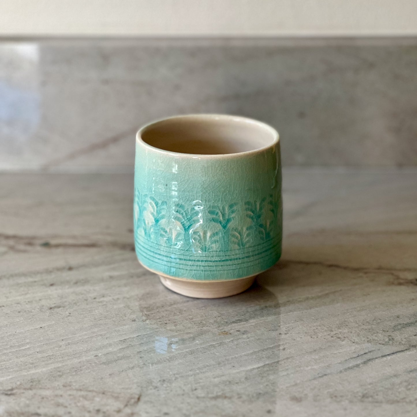 White Clay Cup With Relief Carving and Blue Glaze
