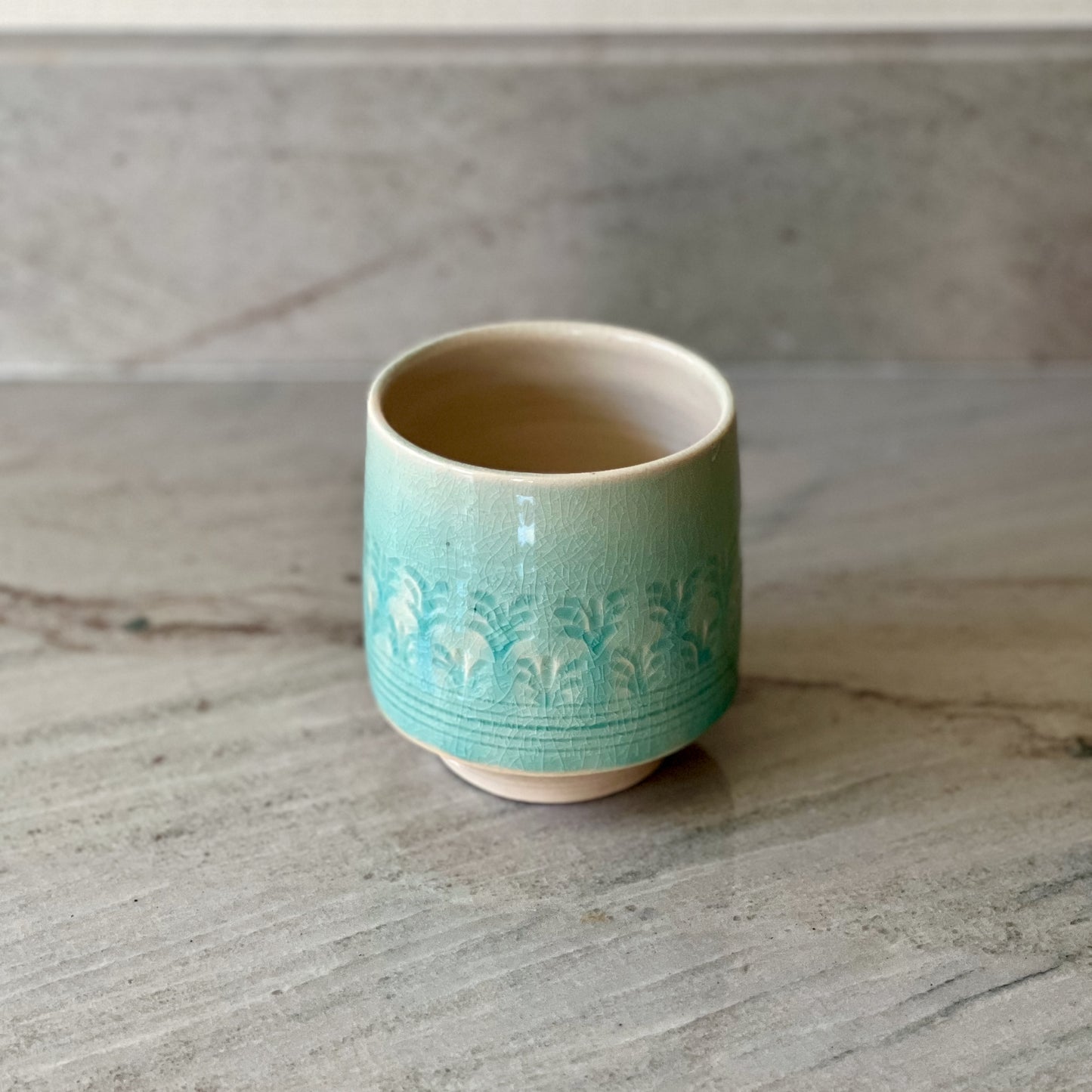 White Clay Cup With Relief Carving and Blue Glaze