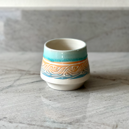 Small Porcelain Cup, Blue and Orange Slip with Blue Glaze
