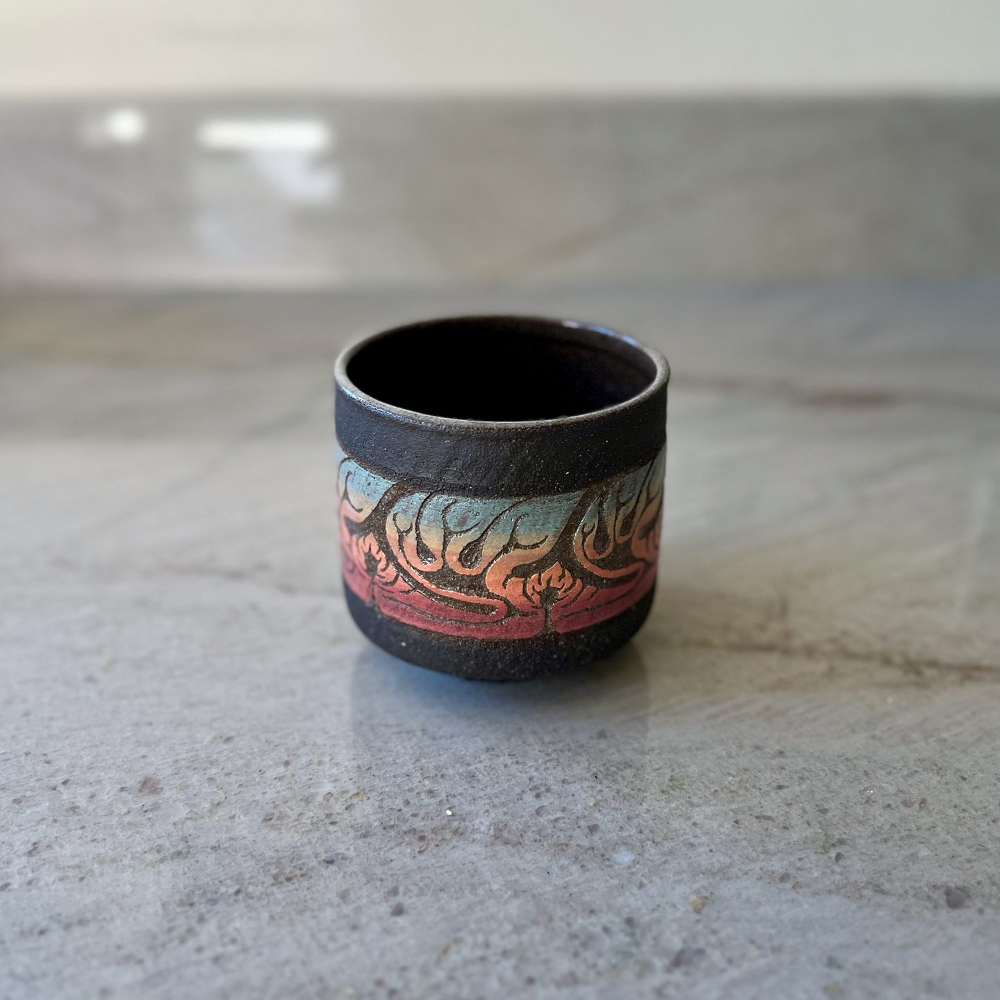 Charcoal Cup with Blue, Orange, and Red Carving