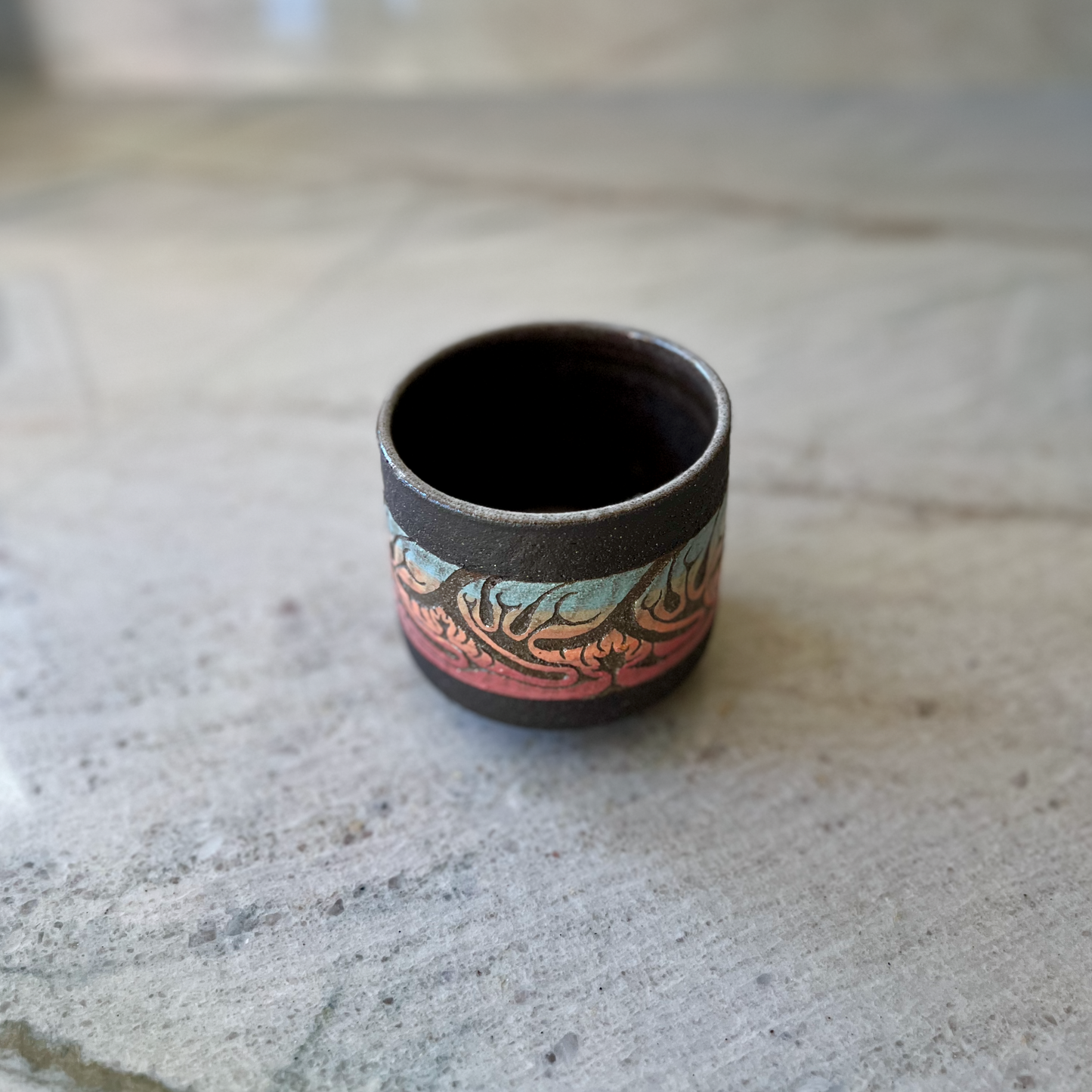 Charcoal Cup with Blue, Orange, and Red Carving