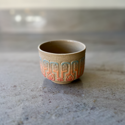 Sandy Clay Teacup with Red, Orange, and Blue Carving