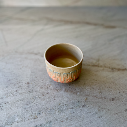 Sandy Clay Teacup with Red, Orange, and Blue Carving