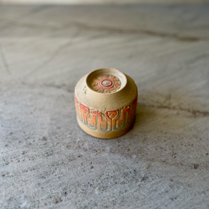 Sandy Clay Teacup with Red, Orange, and Blue Carving